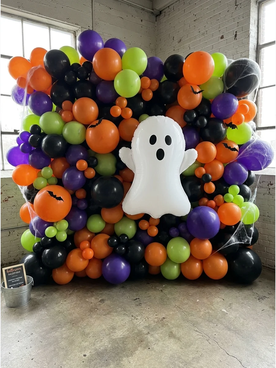A dense wall of orange and black balloons with a giant white ghost in the middle.