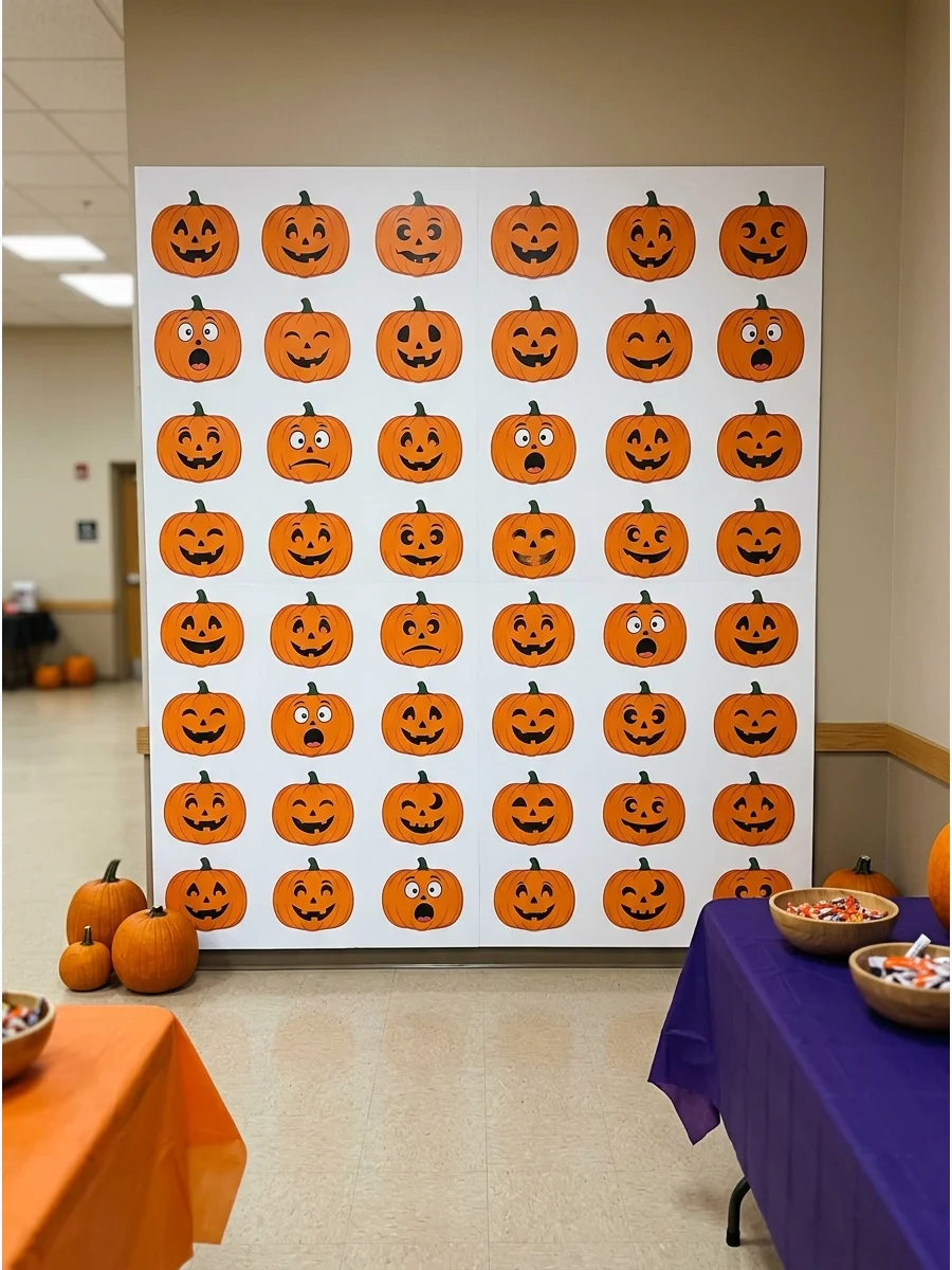 A repeating pattern of pumpkin faces on a white wall for a Halloween backdrop.