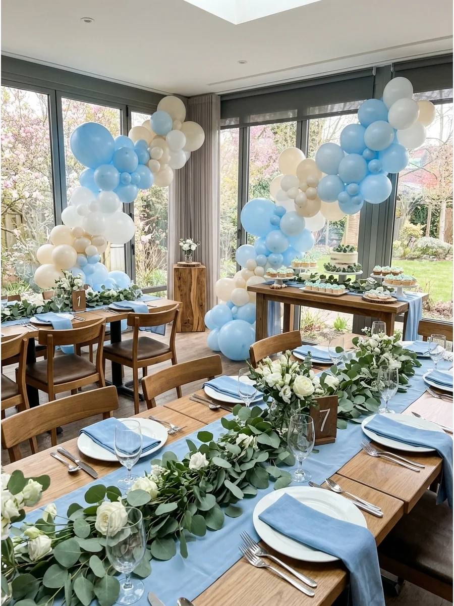Baby blue and eucalyptus baby boy shower decor in a bright dining room.