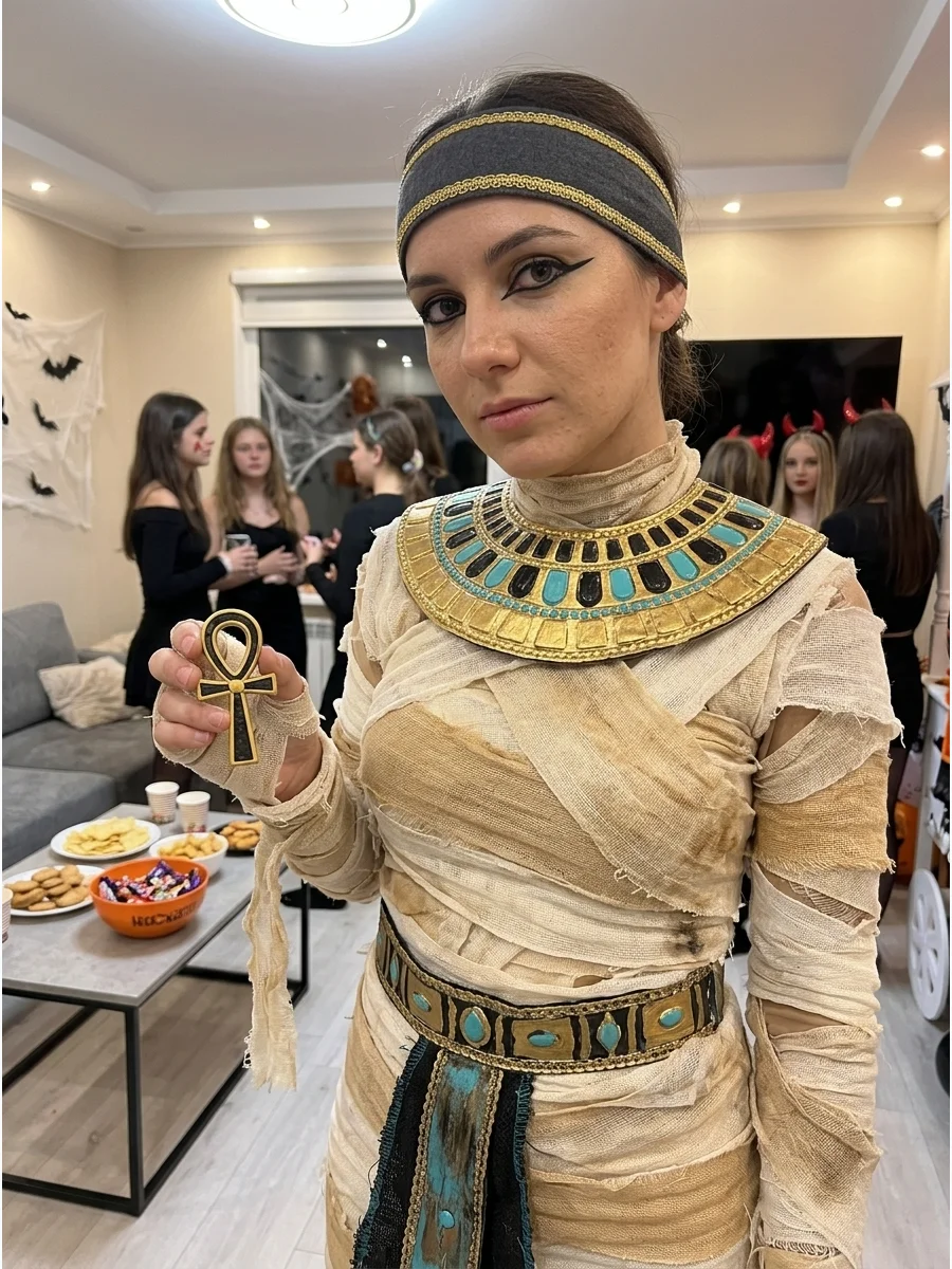 Ancient Egyptian Mummy Costume. Pair weathered wrappings with a gold collar, decorative belt, and Egyptian-inspired eyeliner. Use black and turquoise accessories to introduce color