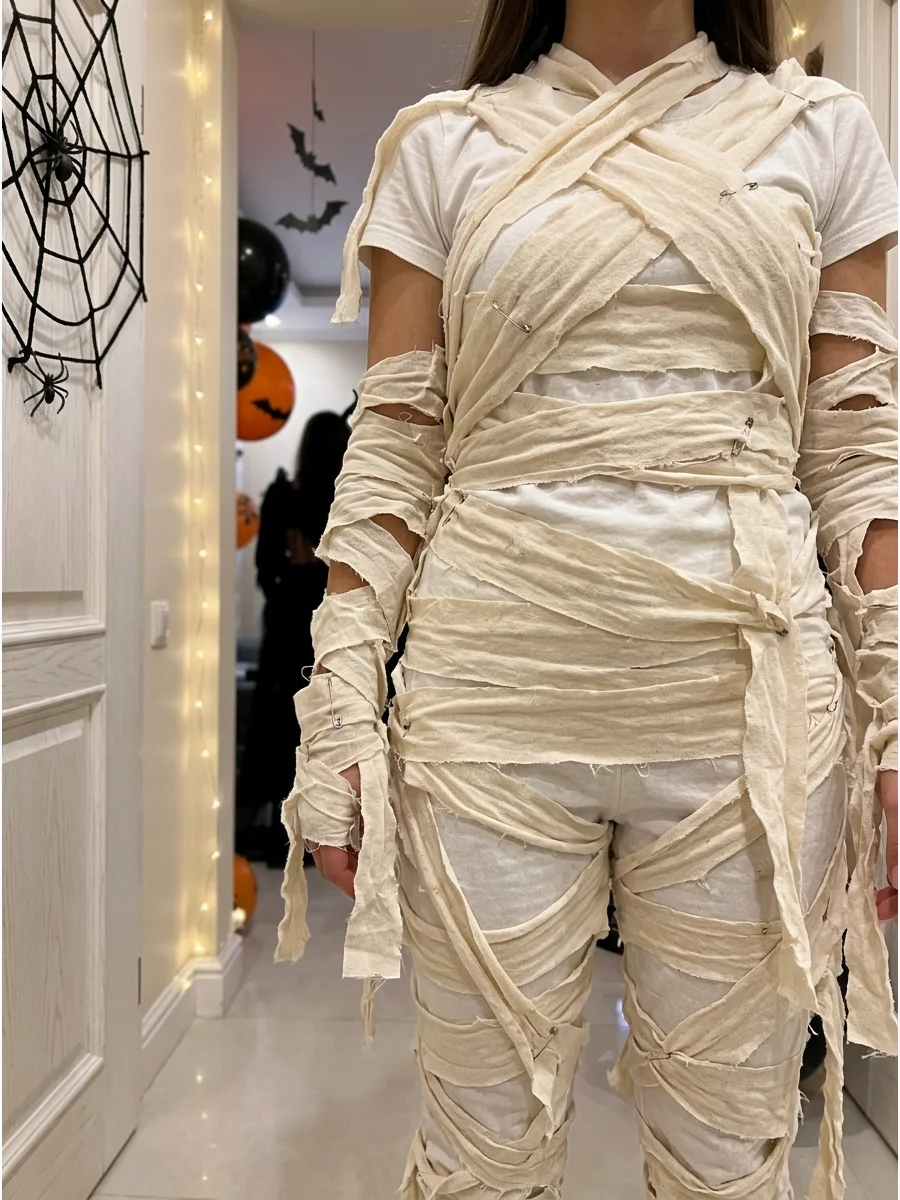 No-Sew Mummy Costume. Use fabric glue or safety pins to attach lightweight cotton strips to an inexpensive white outfit. Overlap the pieces unevenly so the costume looks aged rathe