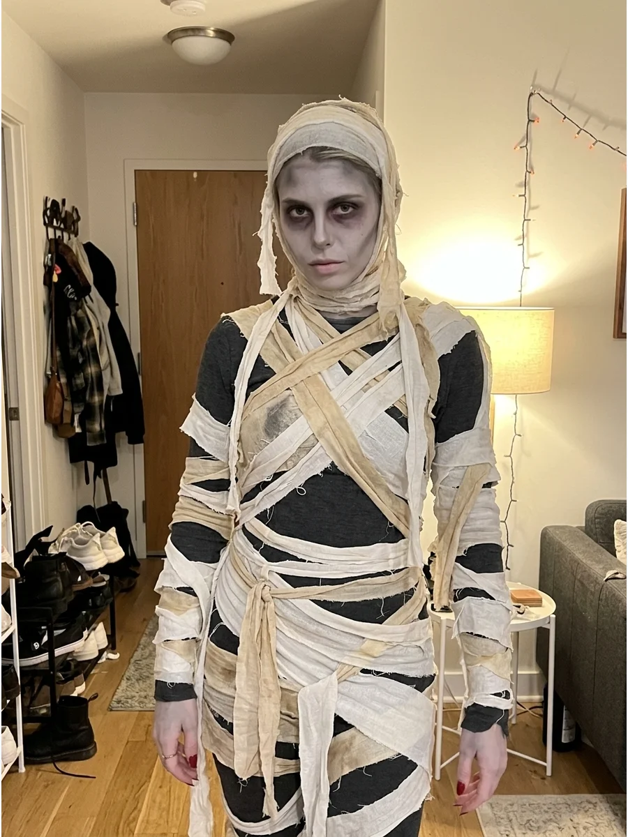 Undead Mummy Costume. Wear torn fabric over dark clothing and add pale gray makeup with deep shadows around the eyes. Keep the details theatrical rather than graphic for a spooky b