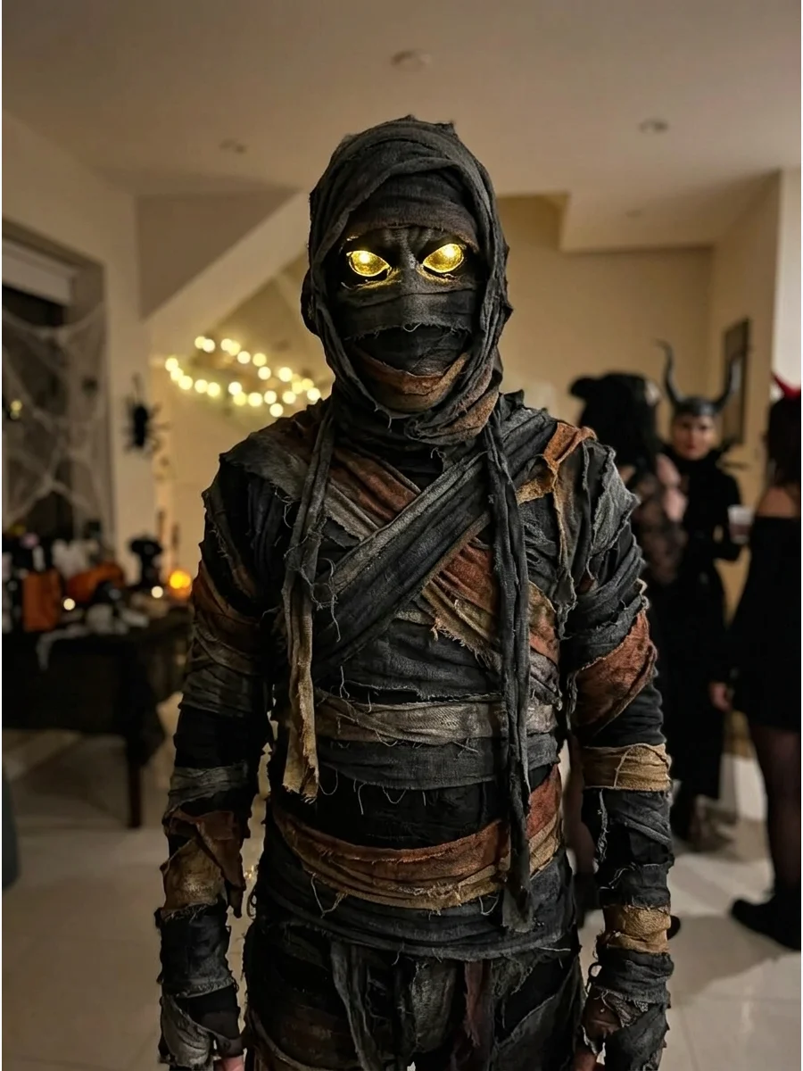 Glowing-Eyes Mummy Costume. Use reflective eye makeup or a removable costume mask beneath a safely positioned mummy hood. Keep the rest of the outfit dark and weathered so the eyes