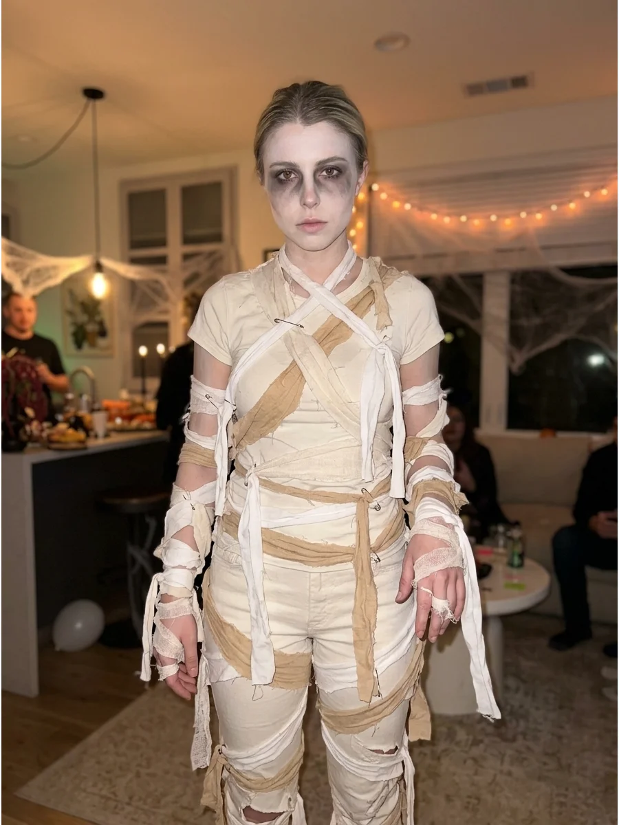 Last-Minute Mummy Costume. Wear white or cream clothing and loosely attach several fabric strips around the arms, legs, and torso. Add pale makeup and dark shading around the eyes