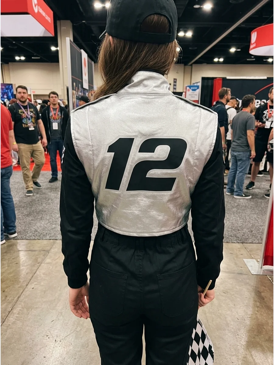 Back view of a silver racing vest featuring a large black number.