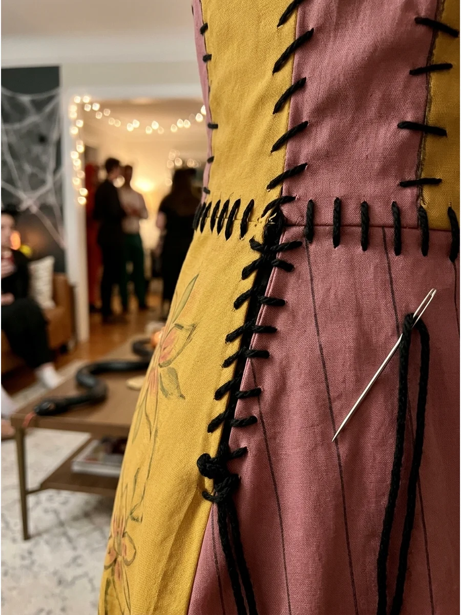 of thick black yarn stitches on a Sally costume.