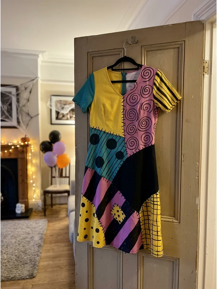 A of a Sally patchwork dress with hand-drawn swirls and stitches.