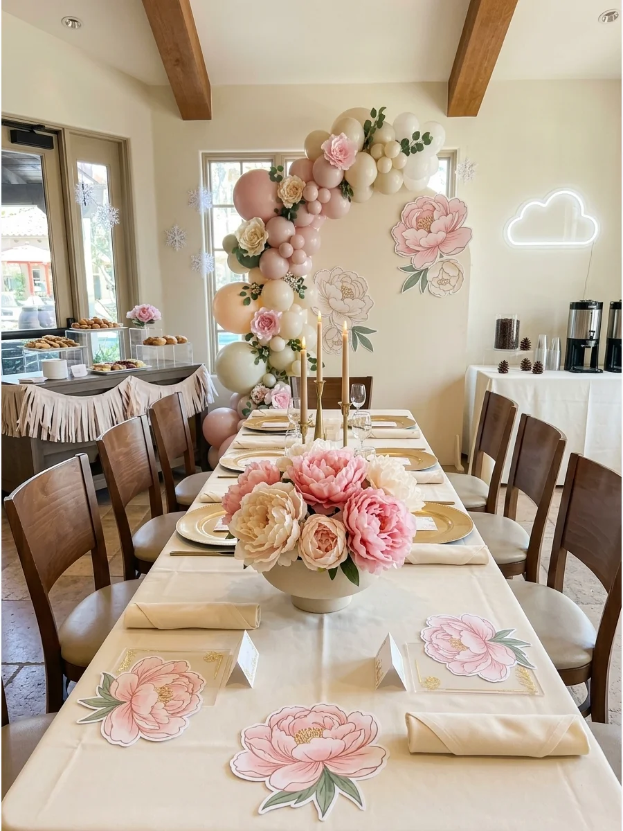 Large pink peonies in a low bowl on a cream table.