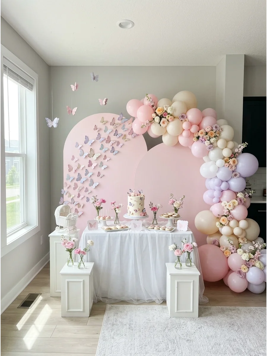 A pink arched backdrop decorated with pairs of 3D paper butterflies for a twin girl shower.