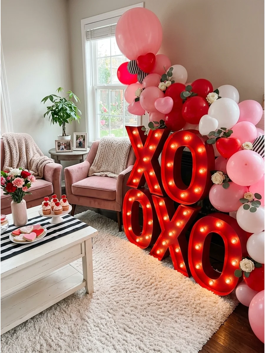 Red X and O marquee letters in a white living room.