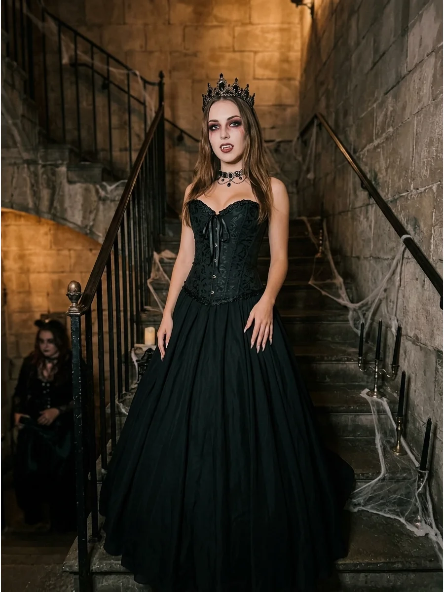 Woman in a black gothic queen vampire costume on stone stairs.