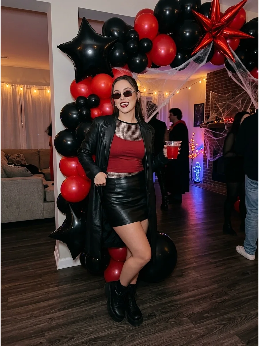 A woman in a Y2K style vampire outfit with small sunglasses.
