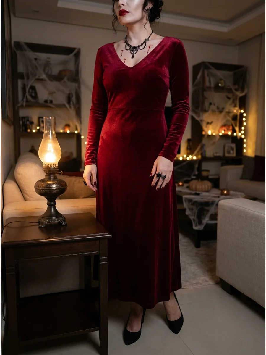 Woman in a crimson red dress with vampire makeup.