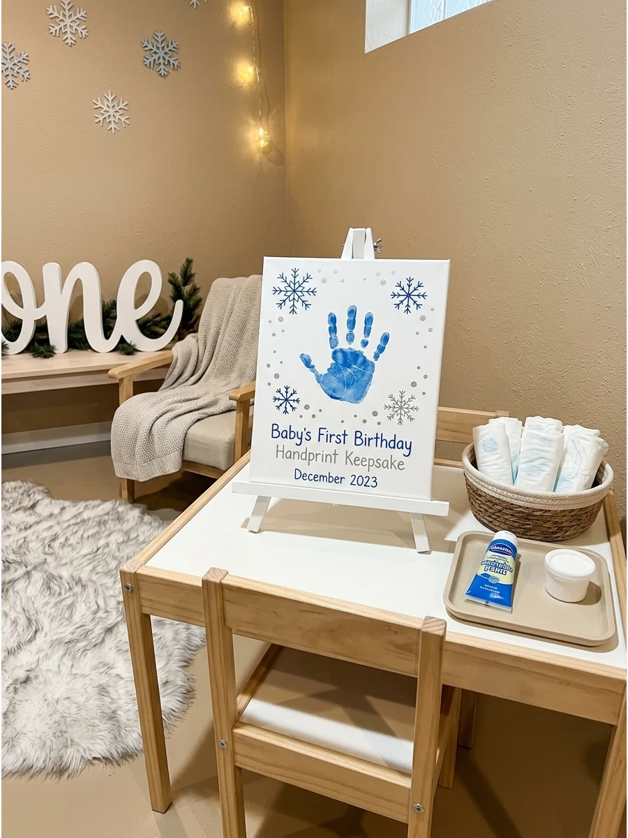 A baby handprint on a canvas decorated to look like a snowflake.