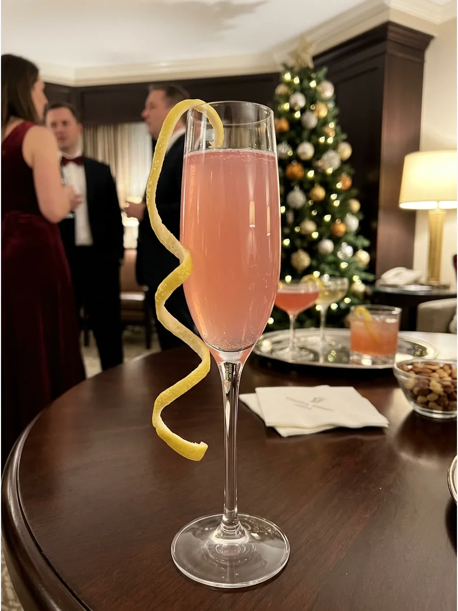 Pink Christmas French 75 cocktail in a champagne flute.