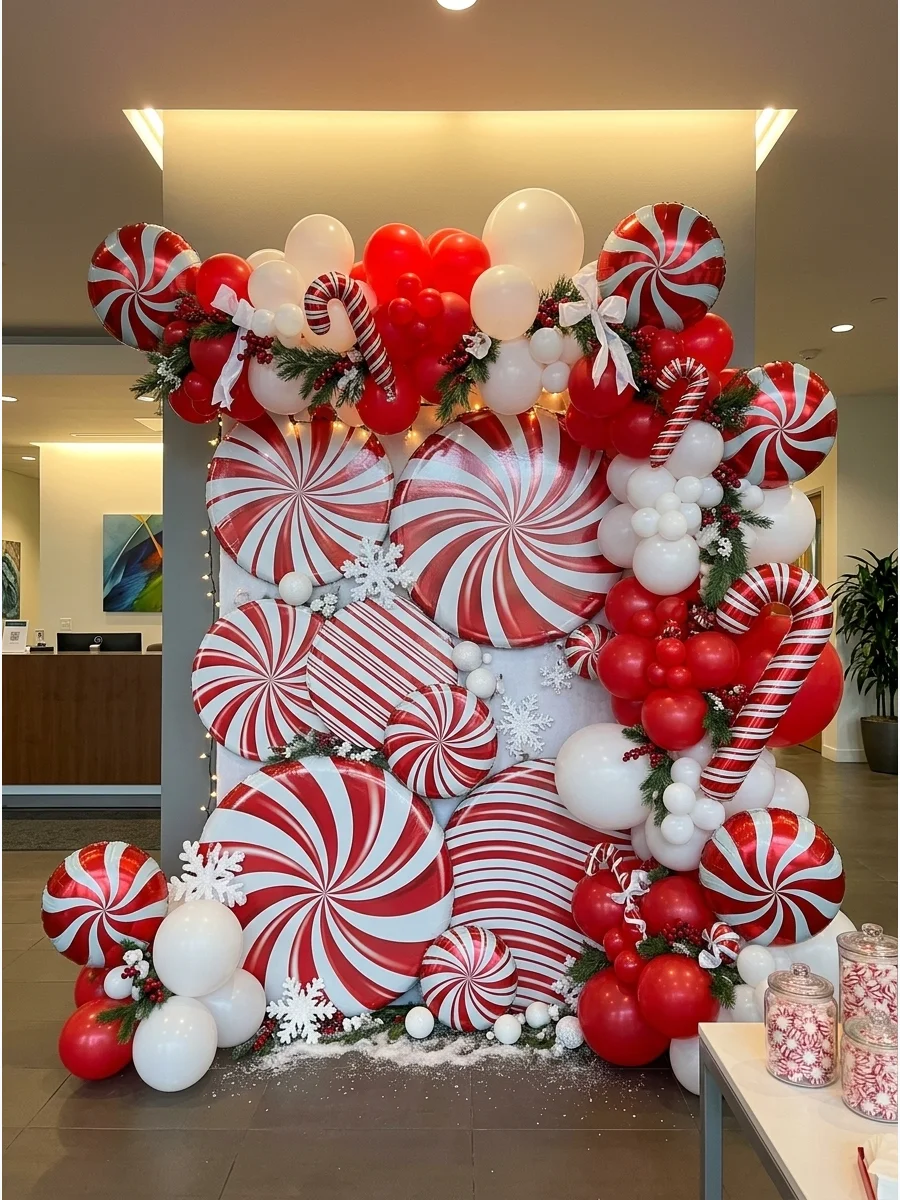 A white wall covered in red and white peppermint candy decorations.