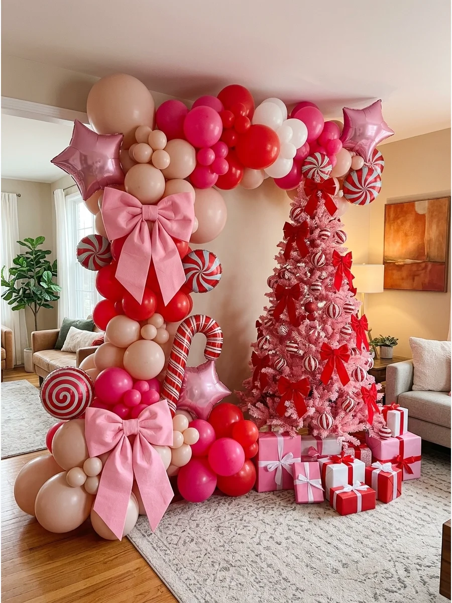 A pink and red Christmas backdrop with a pink tree and large fabric bows.