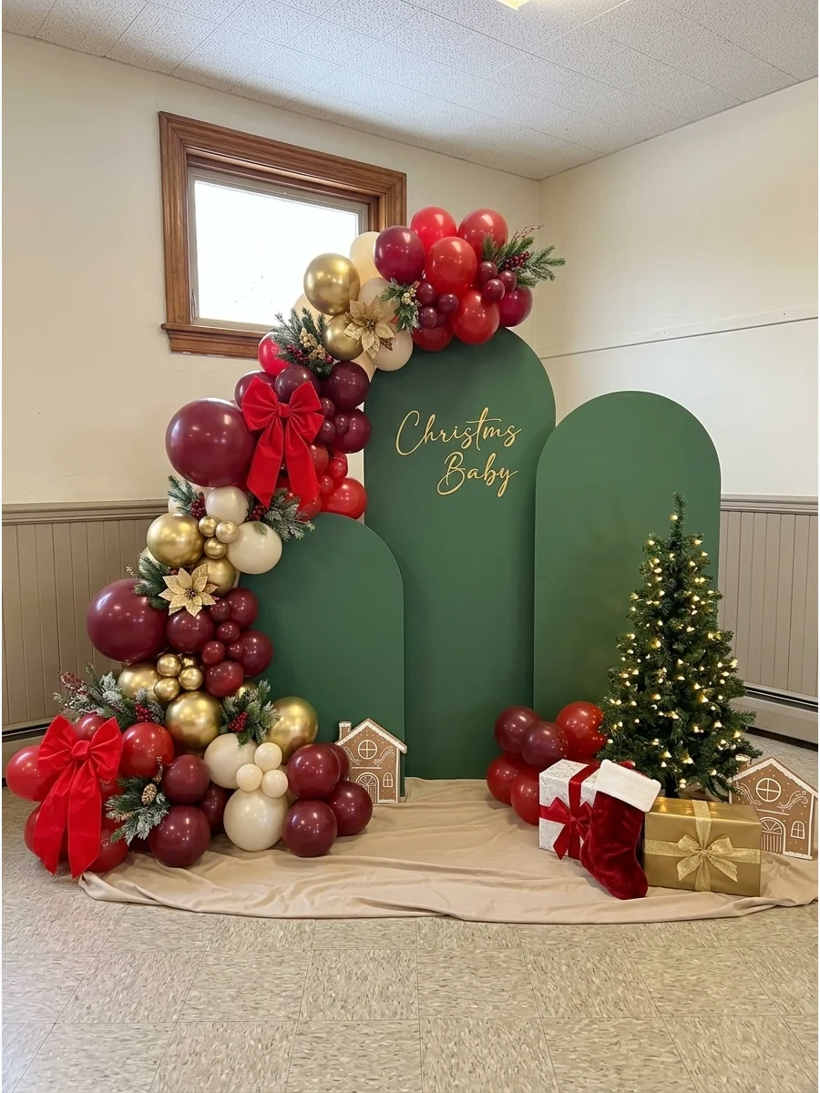 Staggered green arch panels with a red and gold balloon garland.