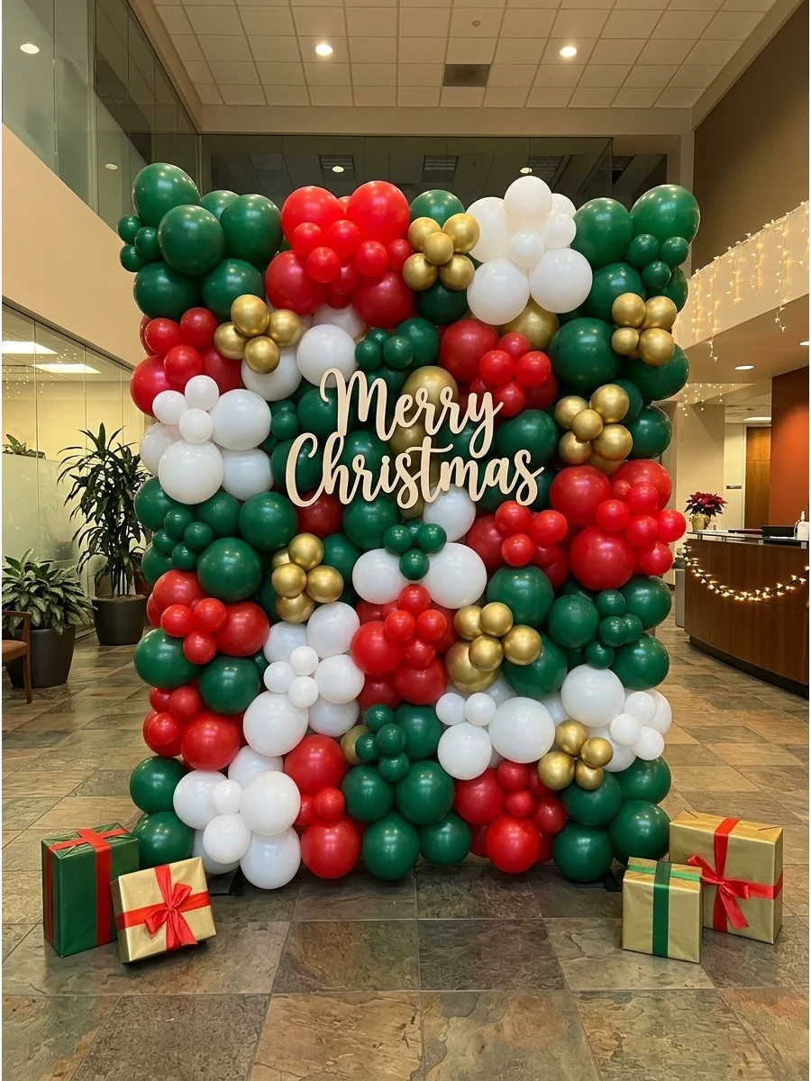 A full wall made of red, green, and gold balloons with a holiday sign.