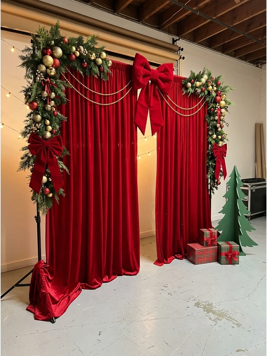 Elegant red curtains used as a Christmas party photo backdrop with gold accents.