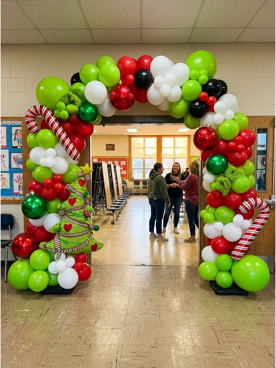 A large arch made of green and red balloons at a school cafeteria entrance.