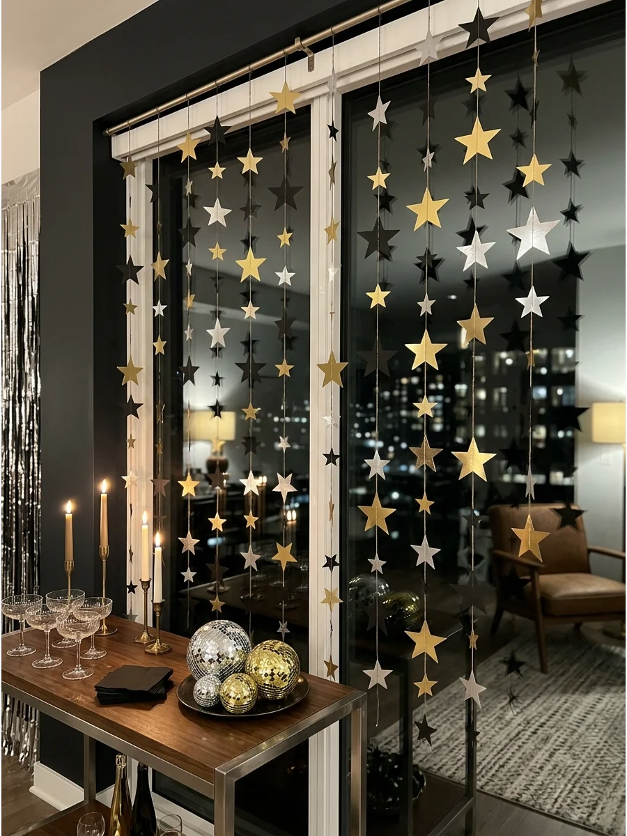 Handmade metallic paper star garlands hanging vertically against a window.