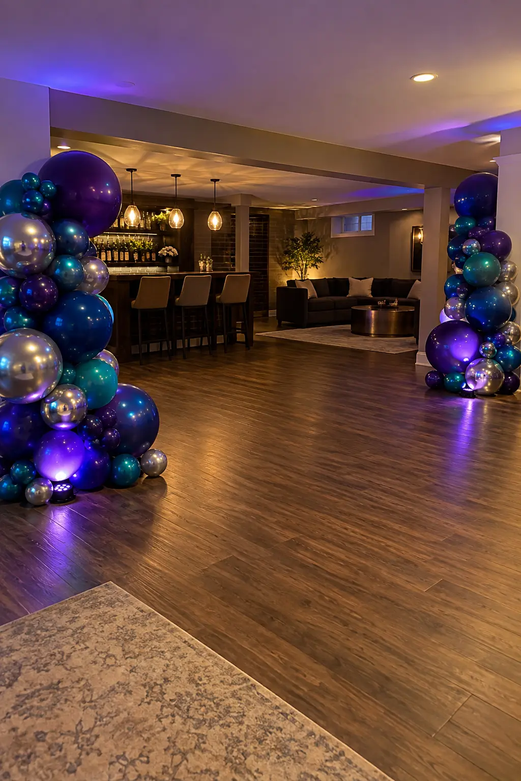 Jewel-tone balloon clusters lit from below at the corners of a dance area