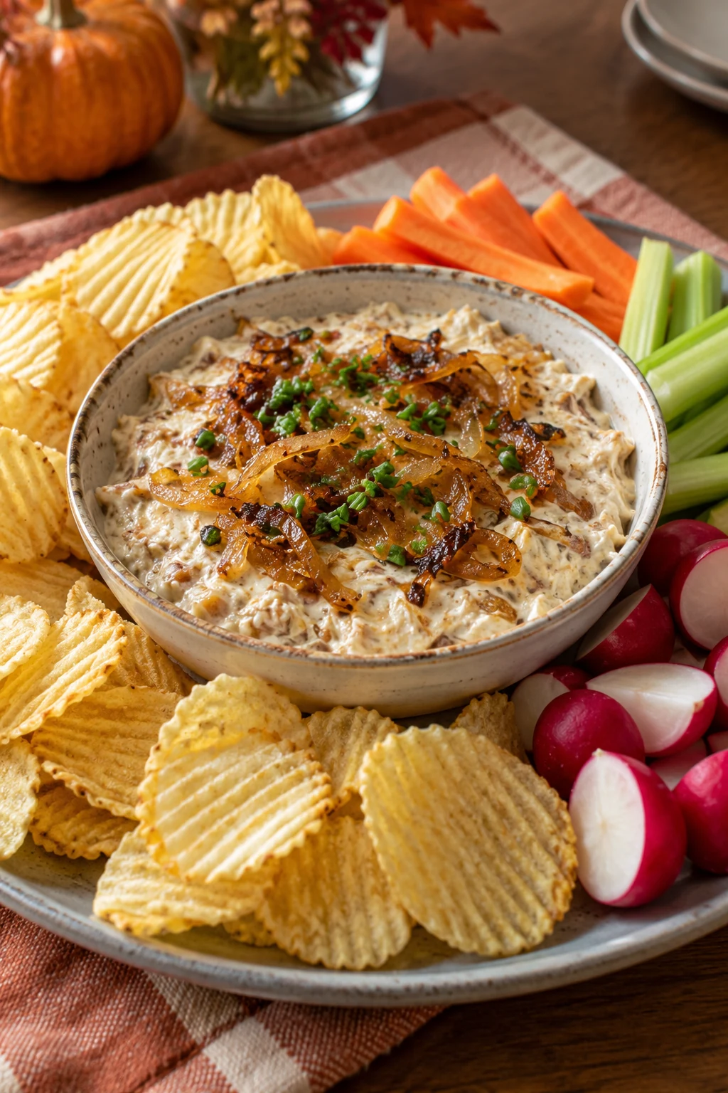 Creamy caramelized onion dip topped with golden onions and chives