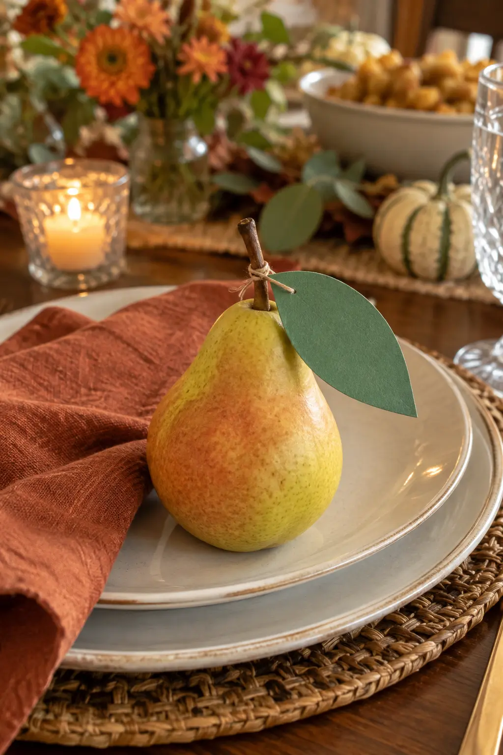 Fresh pear with a green paper leaf tag at a Thanksgiving place setting
